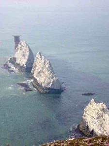 A rocky island in the middle of a body of water